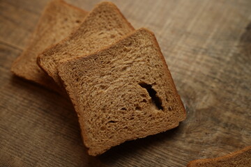 Fototapeta na wymiar Sliced ​​bread on a wooden background.