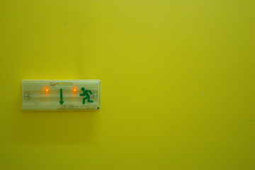 electrical exit sign on green wall