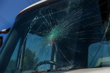 Broken car windshield. Web of radial cracks, crack on triple windshield. Broken windshield car,...