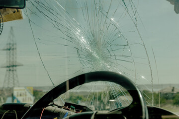 Broken car windshield. Web of radial cracks, crack on triple windshield. Broken windshield car,...