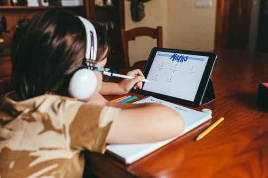 Boy Doing Math Homework With A Touch Pen On His Tablet