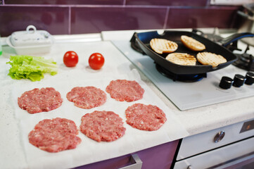 Сooking burgers in the kitchen at home during quarantine time.