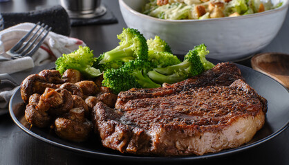 seared ribeye steak with broccoli and sauteed mushrooms