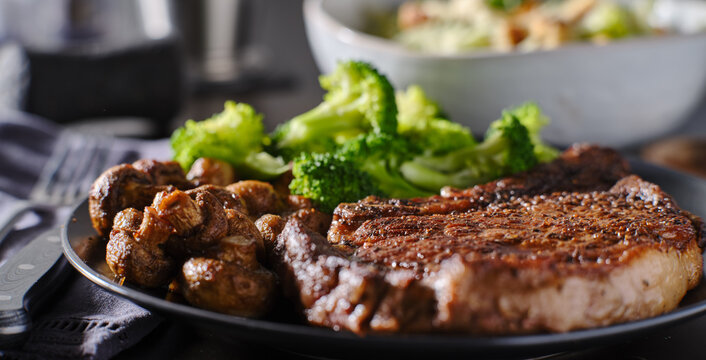seared ribeye steak with broccoli and sauteed mushrooms