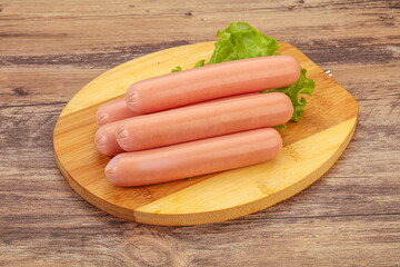 Tasty meat sausages over board