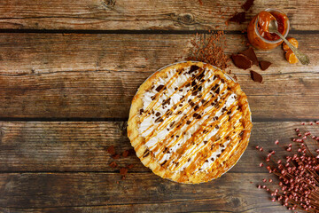 Pie with whipped cream and caramel topping.