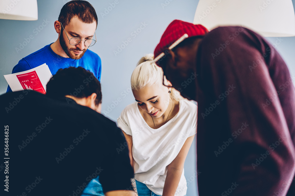 Poster cheerful group of multicultural students searching right route on map