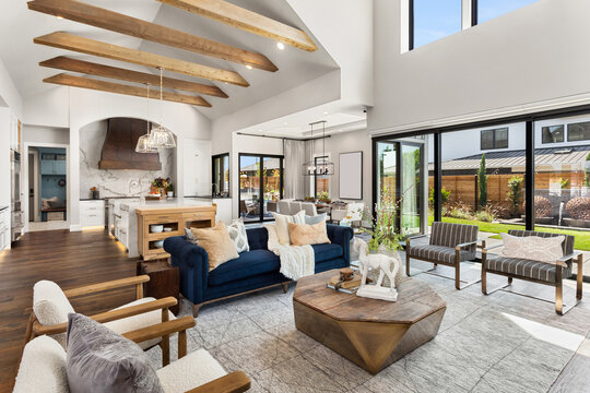 Living room and kitchen interior in new luxury home with large windows