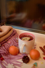 Photo for the New Year card. New Year's composition. View from above. Warm knitted scarf in purple. Tangerines lie on a scarf. Christmas composition with tangerines and a scarf.