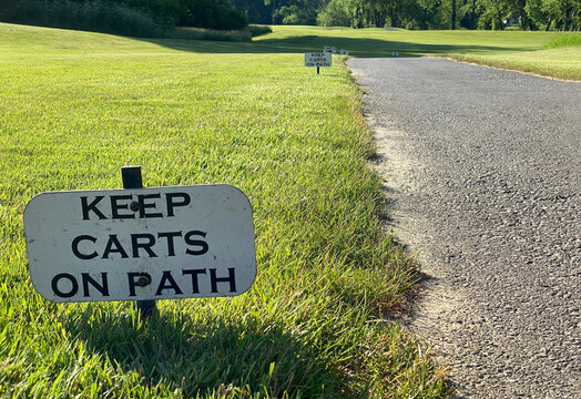 golf course signs display that golf carts are to remain on the cart path
