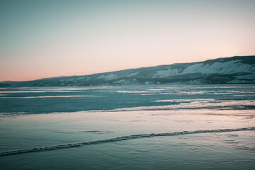 Beautiful crack that goes beyond the horizon on the ice of lake Baikal.