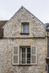 Fototapeta na wymiar Beautiful Old Stone House in medieval city Senlis. Senlis is a commune in Oise department in northern France. 