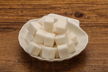 Refined white sugar cubs in the bowl