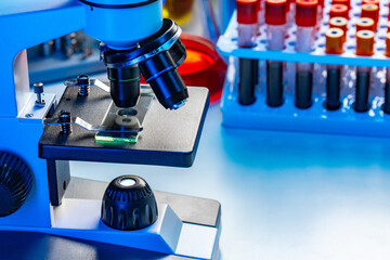 Microscope with blood samples test tubes close up