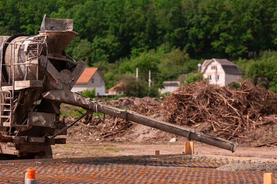 Lay of the cement or concrete into the foundation formwork from concrete mixer