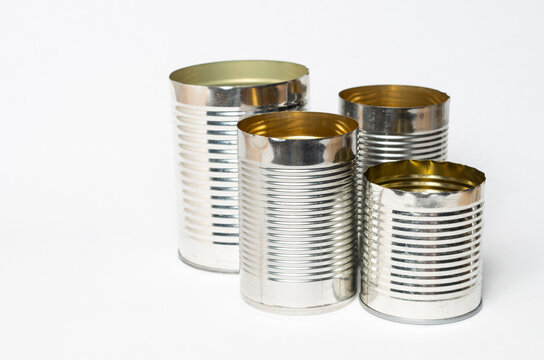 Empty metal cans against a white background