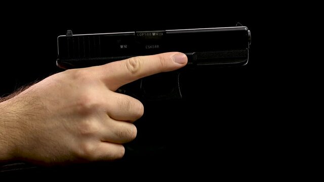 hand holding a gun, reload and misfire