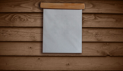 Blank board sign with hanging from wooden background.