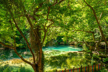 Fototapeta na wymiar Kursunlu waterfall is one of the most attractive landscapes in terms of lush plants and small or big various picnic areas in Antalya.