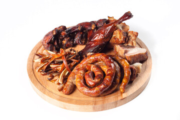 Appetizing set of smoked meat: spiral fried sausage, chicken leg, buffalo chicken wings, sliced smoked meat. On a wooden tray. On a white background in isolation.