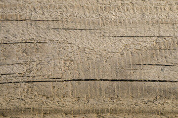 Old wooden boards are fastened with nails. Fragment of an old fence from wooden boards. Grunge texture of wooden boards. Abstract wooden background. The rough texture of the old tree. Deep cracks. 