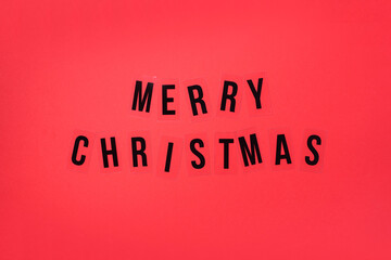 Merry Christmas greeting on red background. Top View. Copy space. Advent time. Decoration for winter holidays celebration. Greeting card
