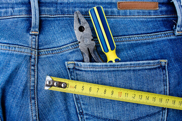 Background with tools in the pocket of blue jeans. Give dad a present. Happy fathers day concept.