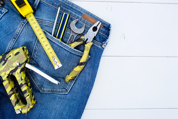 Background with tools in the pocket of blue jeans. Give dad a present. Happy fathers day concept.