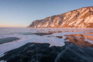 Colorful sunset over the crystal ice of Baikal lake