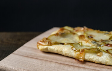 Homemade pizza on a wooden table. On a dark background. Place for text