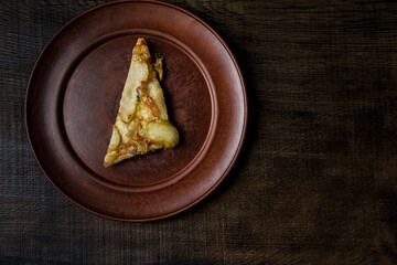Homemade pizza on a wooden table. On a dark background. Place for text
