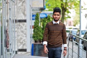 Portrait of young stylish indian man model pose in street.