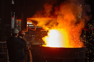 Steelmaker at ingot casting. Electric arc furnace shop EAF. Metallurgy.
