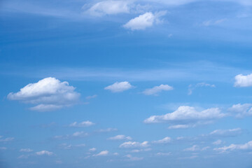 Fototapeta premium Bright beautiful blue sky with soft clouds, bright sunny day