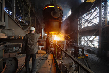 Steelmaker at ingot casting. Electric arc furnace shop EAF. Metallurgy.