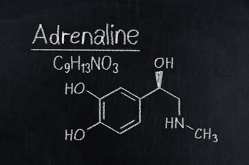 Black chalkboard with the chemical formula of Adrenaline