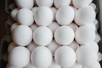 Tray of white fresh eggs close-up on a cardboard form. Agricultural industry