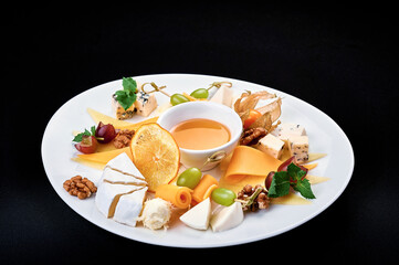 tasty cheese plate with honey on a big white plate