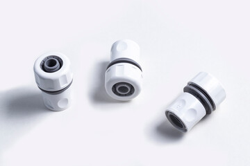 white plastic fitting for garden hose. On white background. No isolation