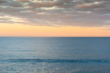 Sky and sea at dusk, with colorful clouds and lightly acted sea