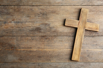 Naklejka na ściany i meble Christian cross on wooden background, top view with space for text. Religion concept