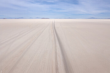 Aerial morning of a 4x4 on Uyuni salar. South of Bolivia.