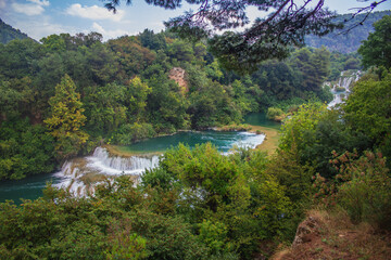 Fototapeta na wymiar Krka National Park. Waterfall and wild landscape at famous tourist attraction in Croatia