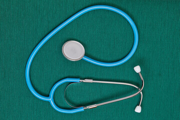 Doctor tool stethoscope on a green background.