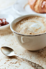  Coffee with milk on bright stone background. Close up.