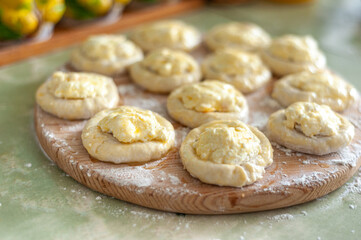 The process of making pies with cottage cheese. Raw pies