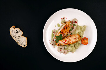 healthy tasty food on a white plate lies on a black background.