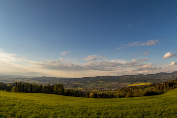 Fototapeta premium Landscape with lots of clouds in the mountainous area of the Beskydy Mountains during a sunny afternoon.