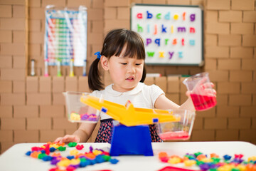 toddler girl play balance toy for homeschooling