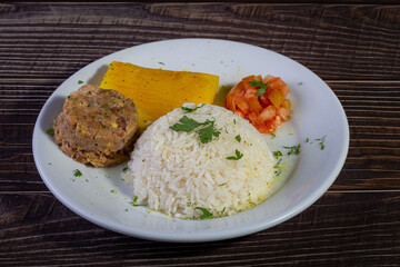 Rice and beans, traditional brazilian dish with manioc and salad.